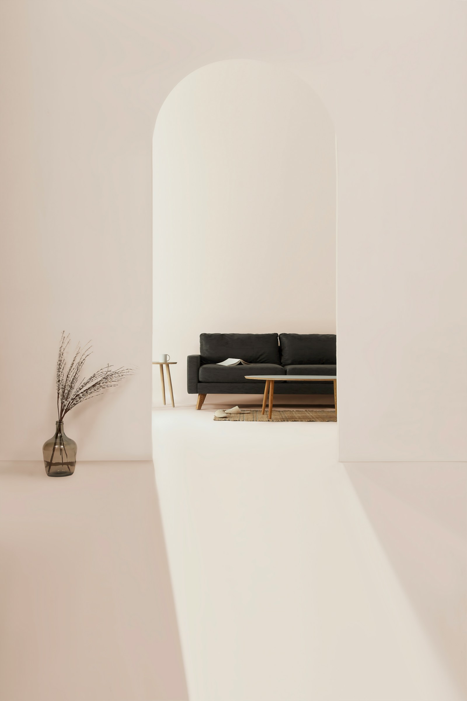 A calm, light-filled lounge with a couch and warm minimal furnishings